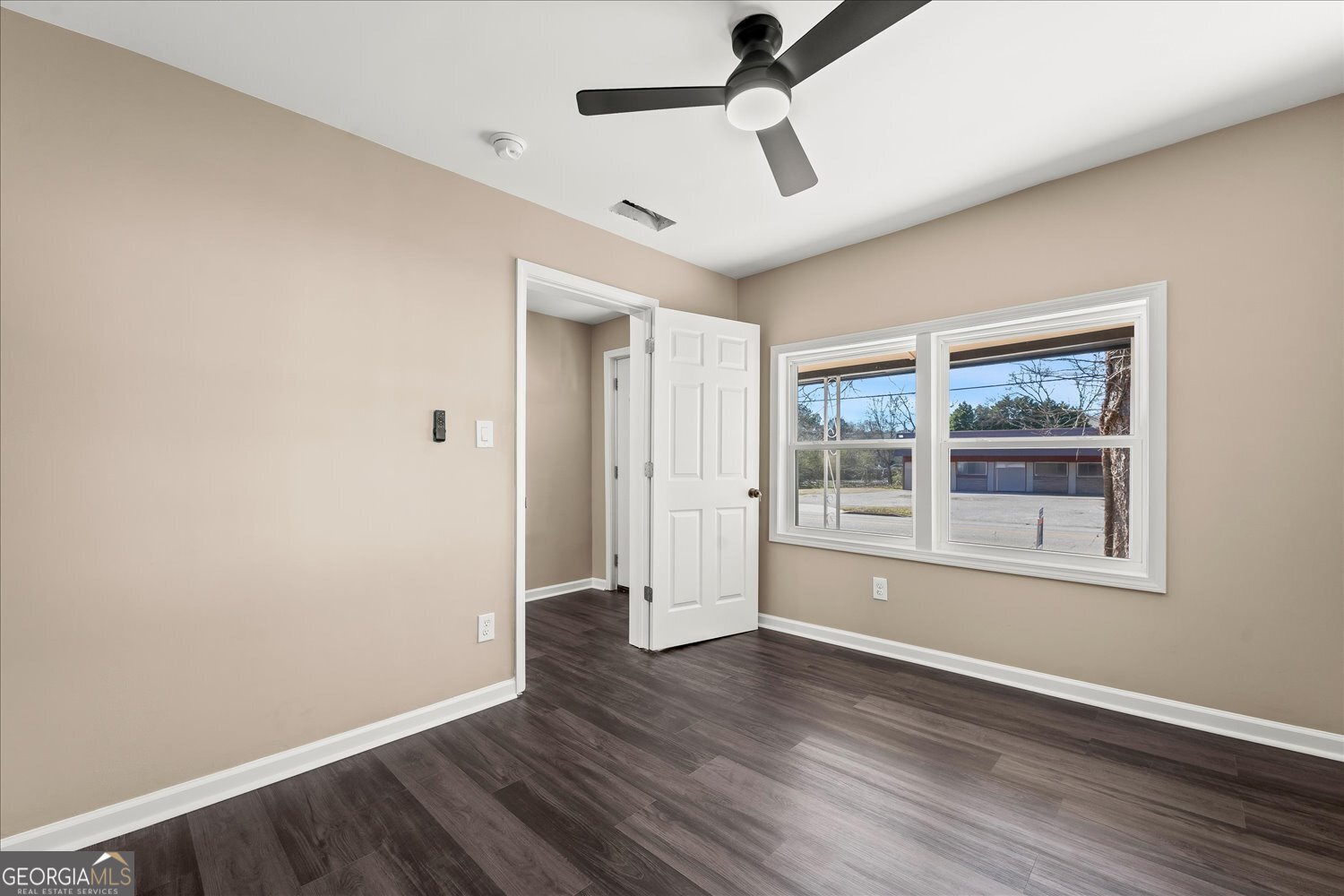 401 Baltimore Road Washington, GA 30673 - Photo 6 of 22 a view of empty room with wooden floor and fan