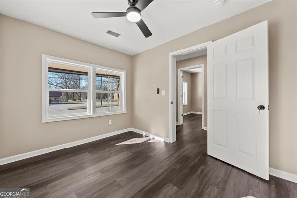 a kitchen with white cabinets and sink