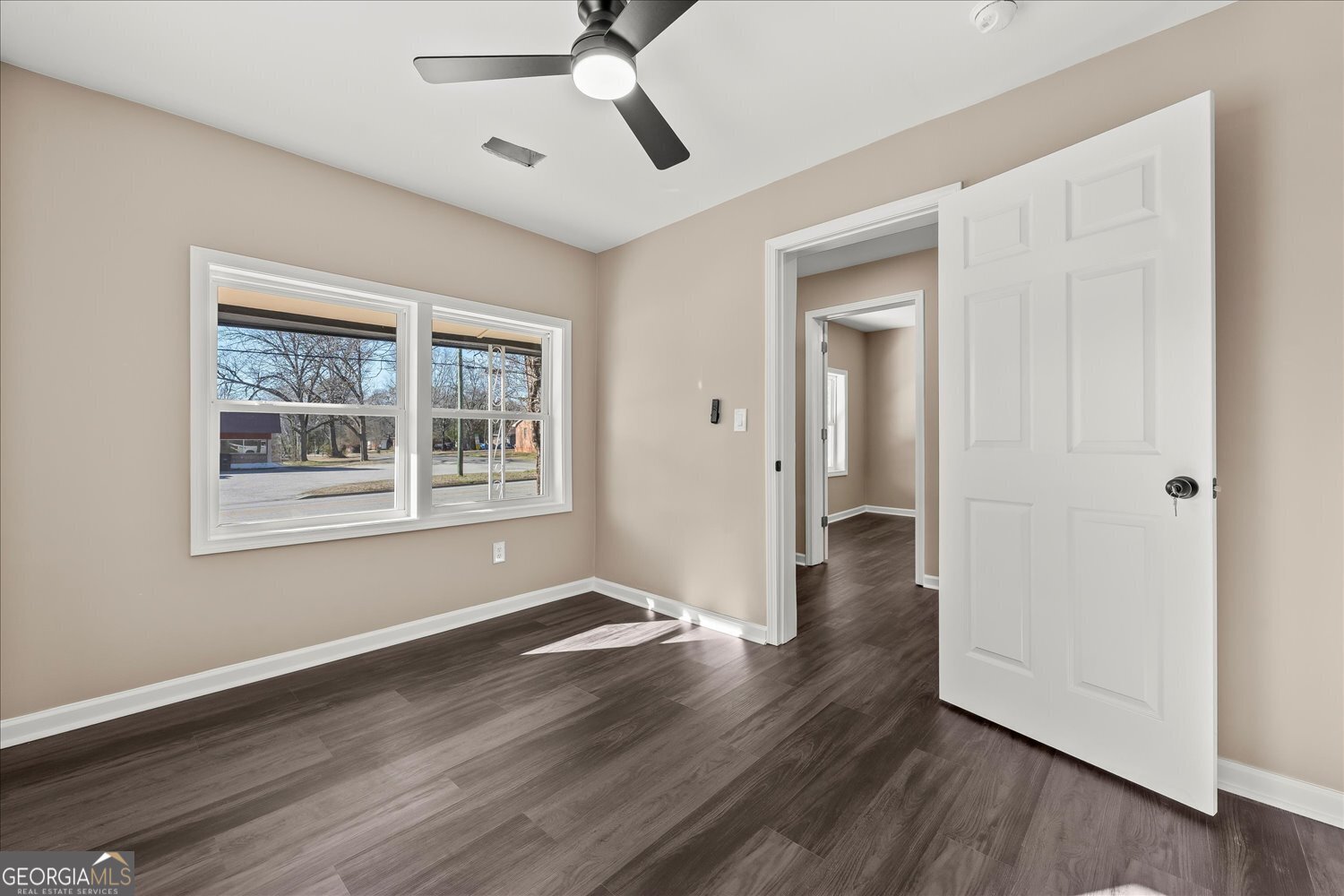 401 Baltimore Road Washington, GA 30673 - Photo 8 of 22 a view of an empty room with wooden floor and a window
