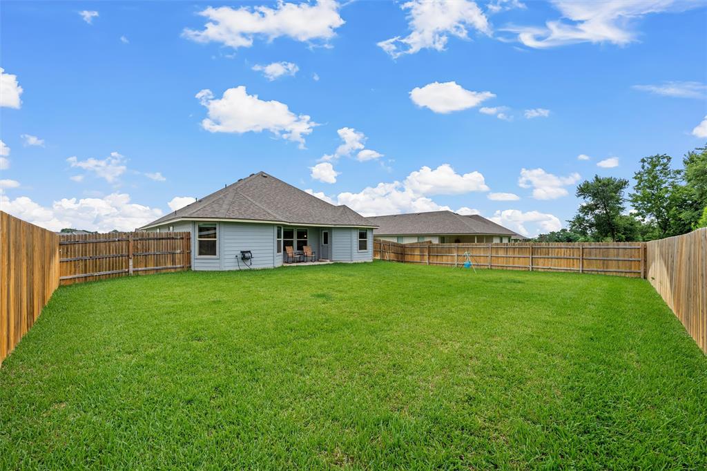 10712 Peperak Court Waco, TX 76708 - Photo 20 of 25 a view of a big house with a big yard
