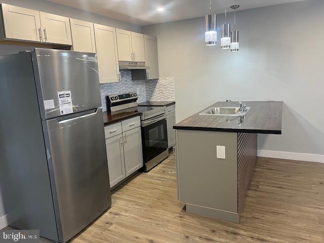 6339 Morton Street Philadelphia, PA 19144 - Photo 5 of 14 a kitchen with stainless steel appliances granite countertop a refrigerator a sink dishwasher a stove and a refrigerator