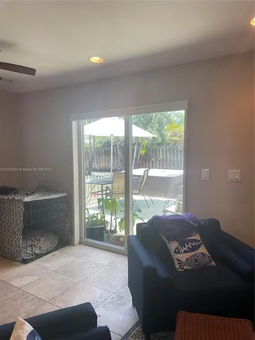 a living room with furniture and a floor to ceiling window