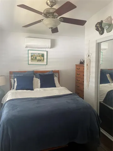 a bedroom with a bed and painting on the wall