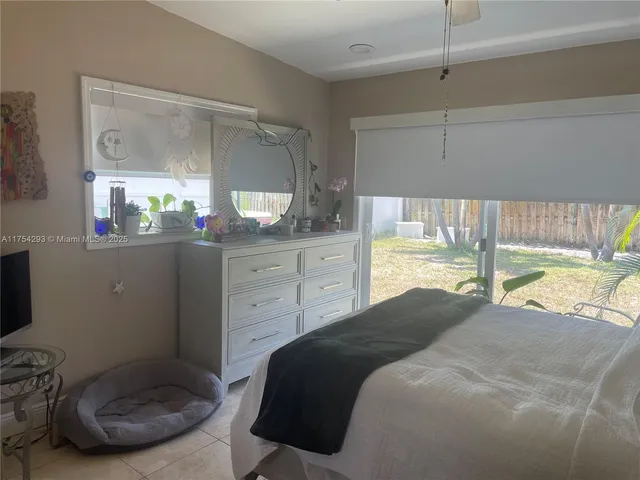 a bedroom with a bed and a mirror