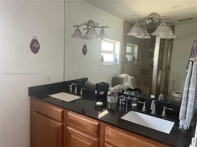 a bathroom with a sink mirror and vanity