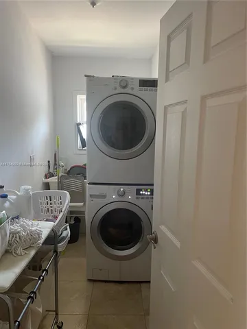 a utility room with sink dryer and washer