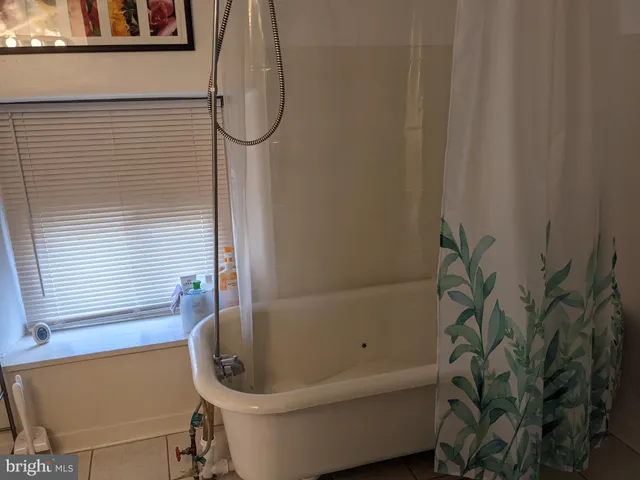 a bathroom with a toilet and a bathtub