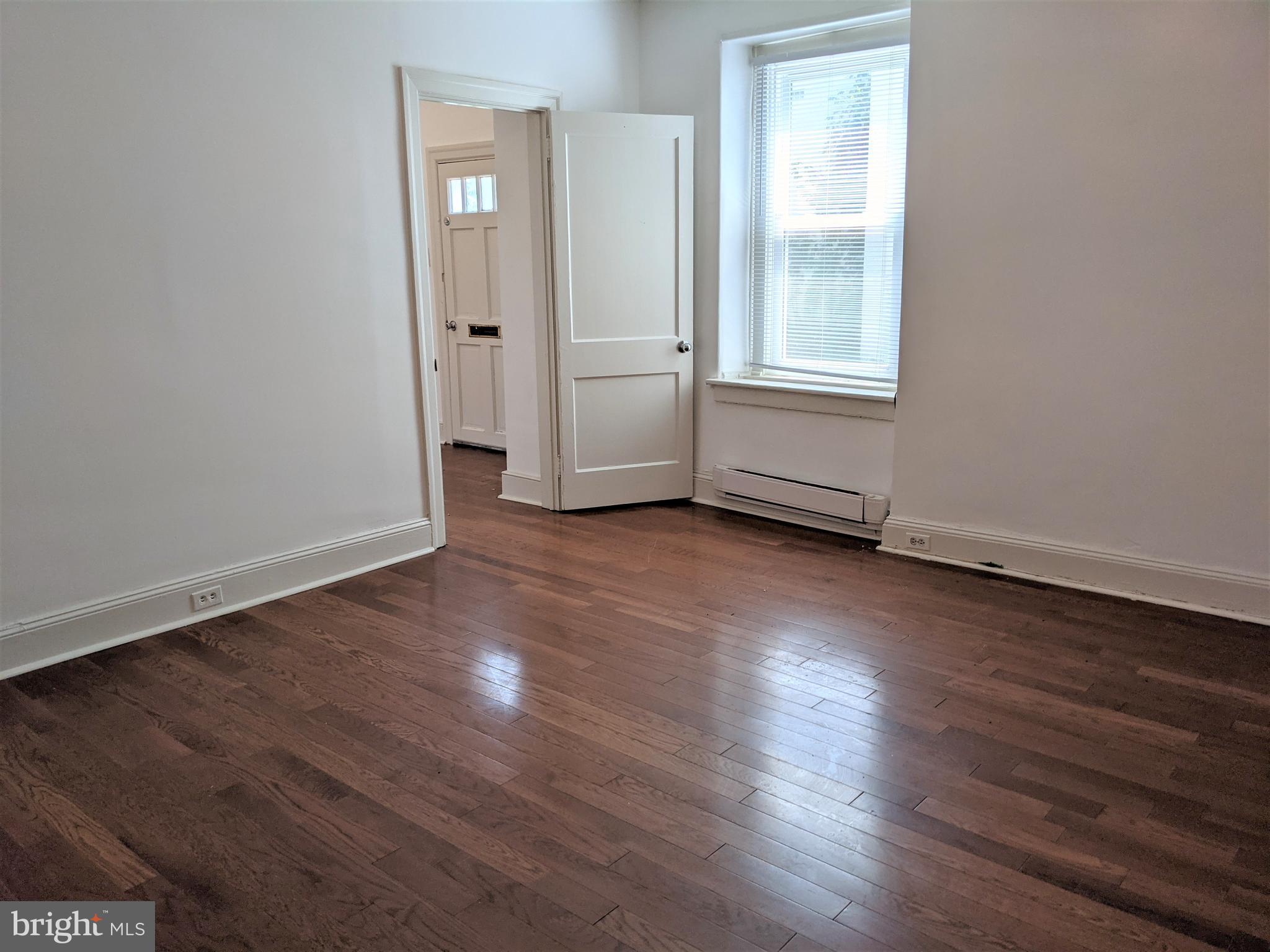 7101 Ridge Avenue Philadelphia, PA 19128 - Photo 4 of 19 an empty room with wooden floor and windows