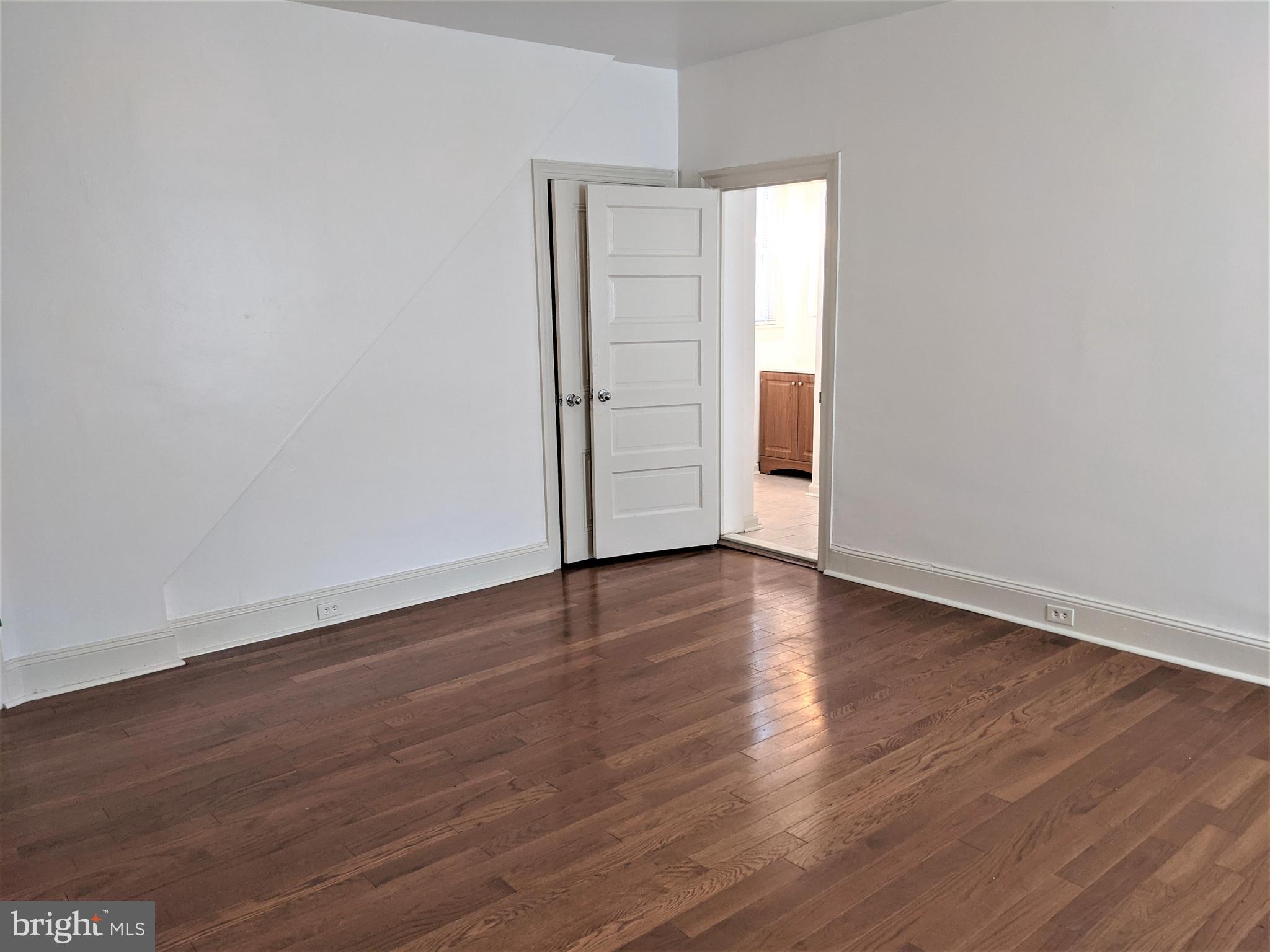 7101 Ridge Avenue Philadelphia, PA 19128 - Photo 5 of 19 an empty room with wooden floor and window