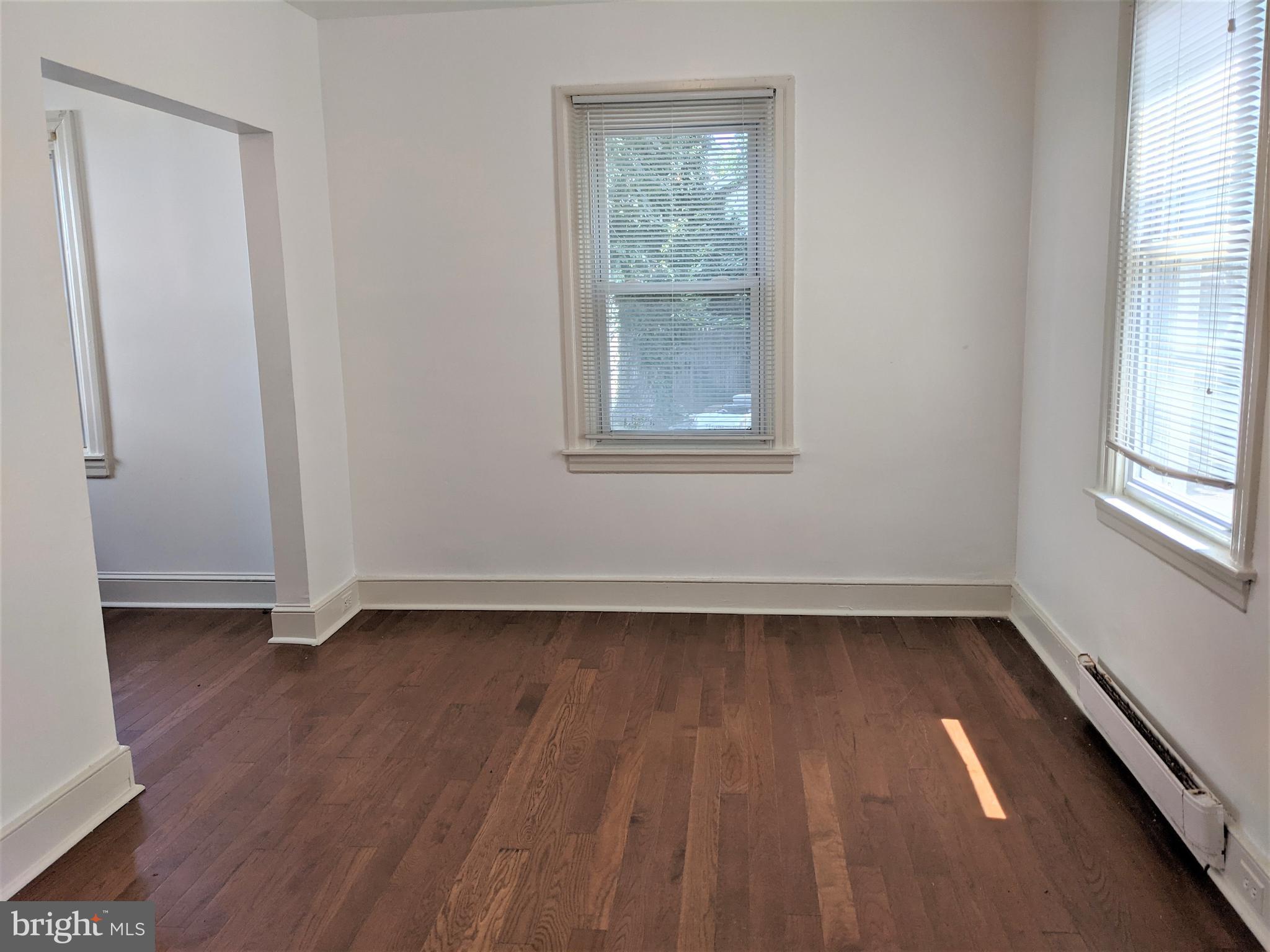 7101 Ridge Avenue Philadelphia, PA 19128 - Photo 6 of 19 an empty room with wooden floor and windows