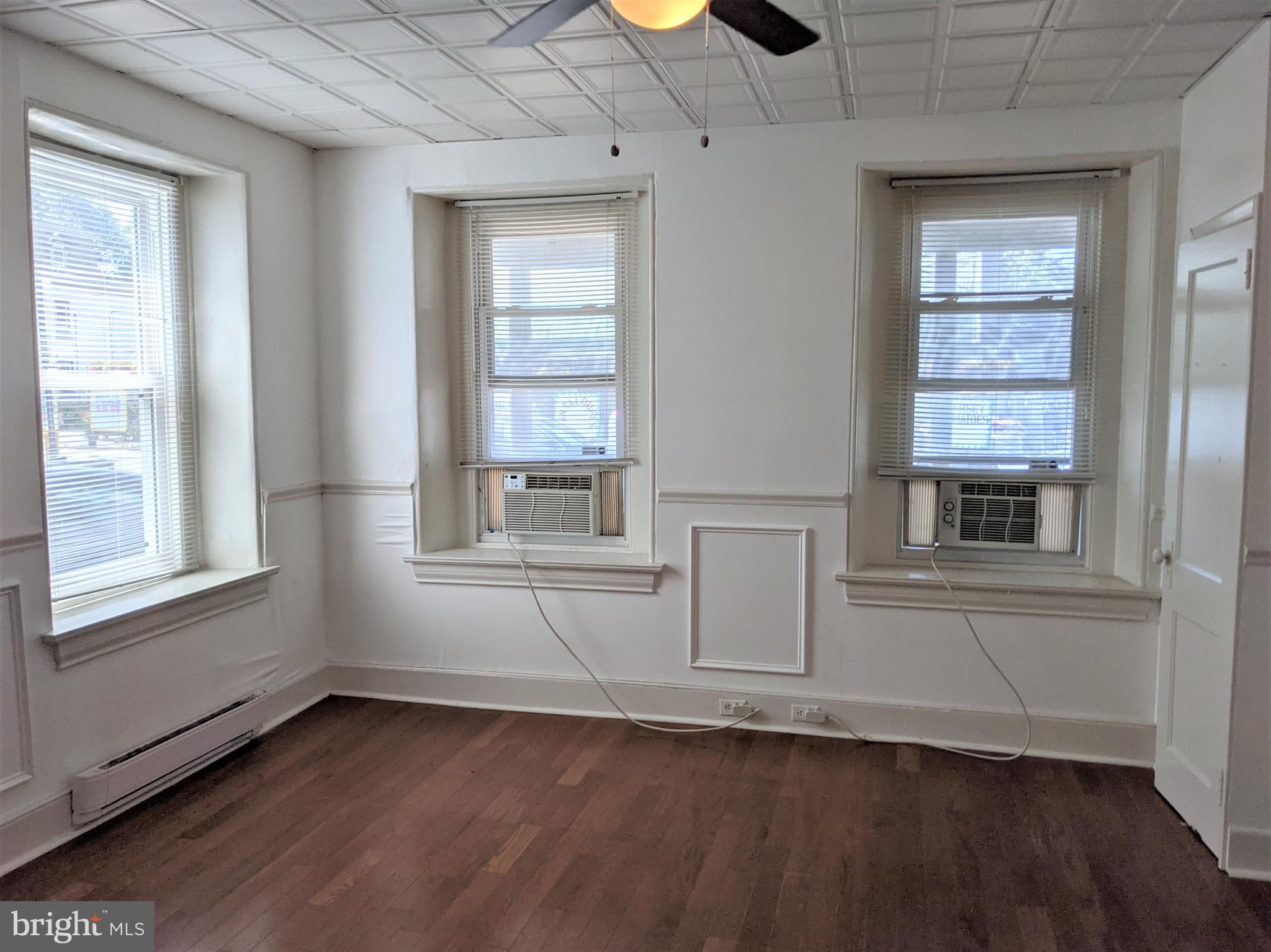 7101 Ridge Avenue Philadelphia, PA 19128 - Photo 9 of 19 an empty room with wooden floor and windows