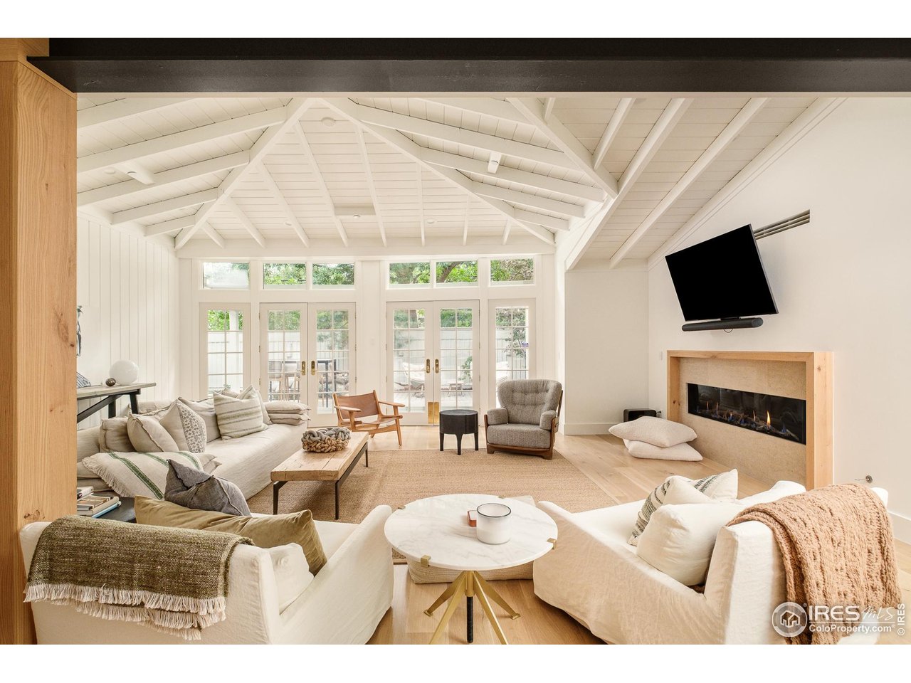 656 Juniper Avenue Boulder, CO 80304 - Photo 16 of 49 a living room with furniture a flat screen tv and a fireplace