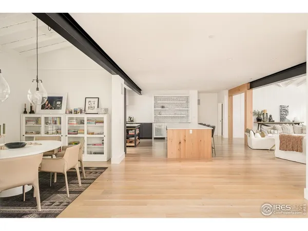a living room with furniture and view of kitchen