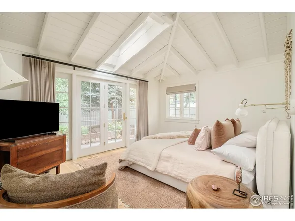 a bedroom with a bed and glass door