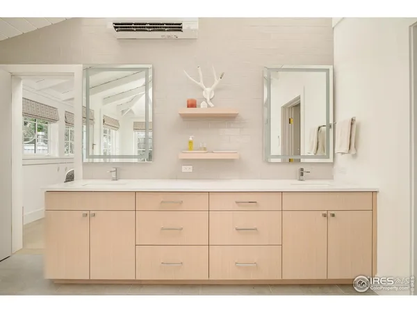a spacious bathroom with a double vanity sink a mirror and a bathtub