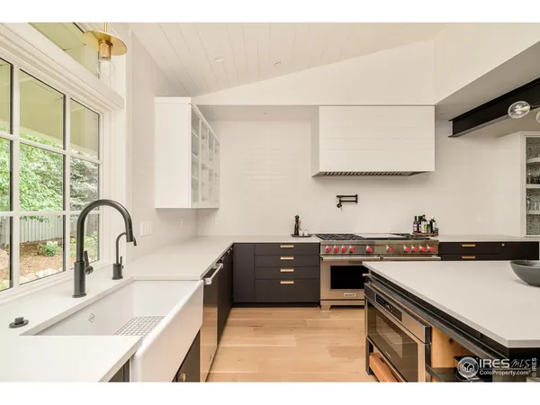 a kitchen with a sink stove and cabinets