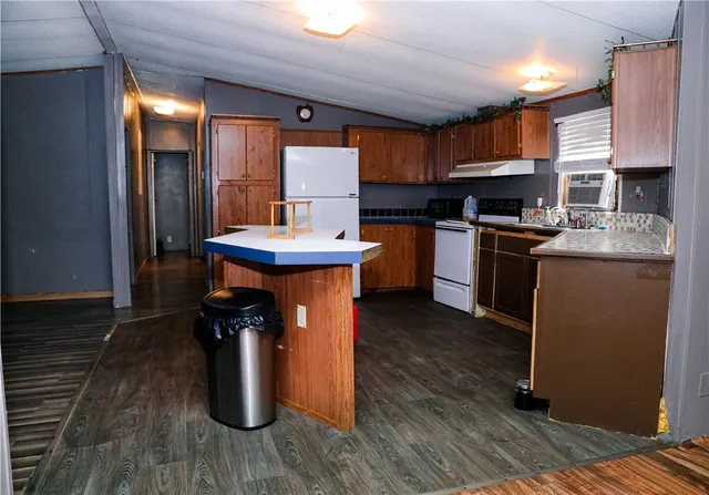 a kitchen with refrigerator and cabinets