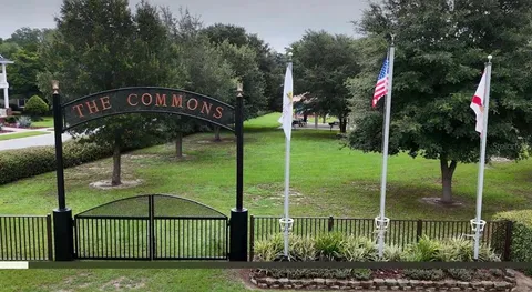 a view of a park with iron fence