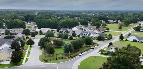 an aerial view of a house with outdoor space and street view