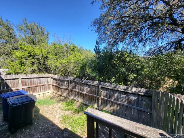 a view of a wooden deck and a backyard