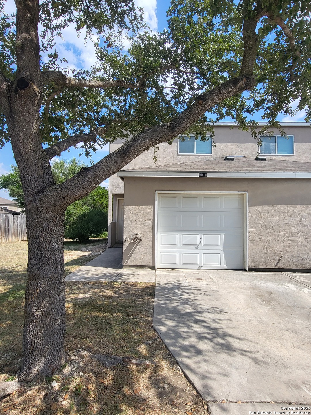 9018 Maverick Draw San Antonio, TX 78250 - Photo 2 of 11 a front view of a house with a yard and garage