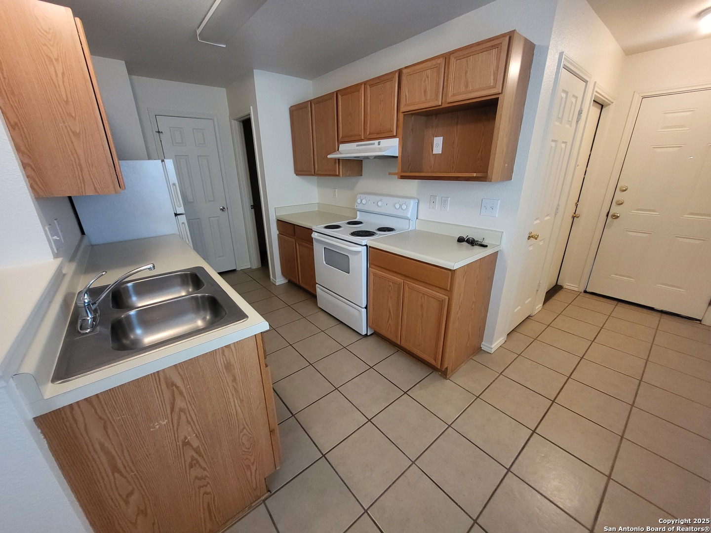 9018 Maverick Draw San Antonio, TX 78250 - Photo 4 of 11 a kitchen with a stove and a sink