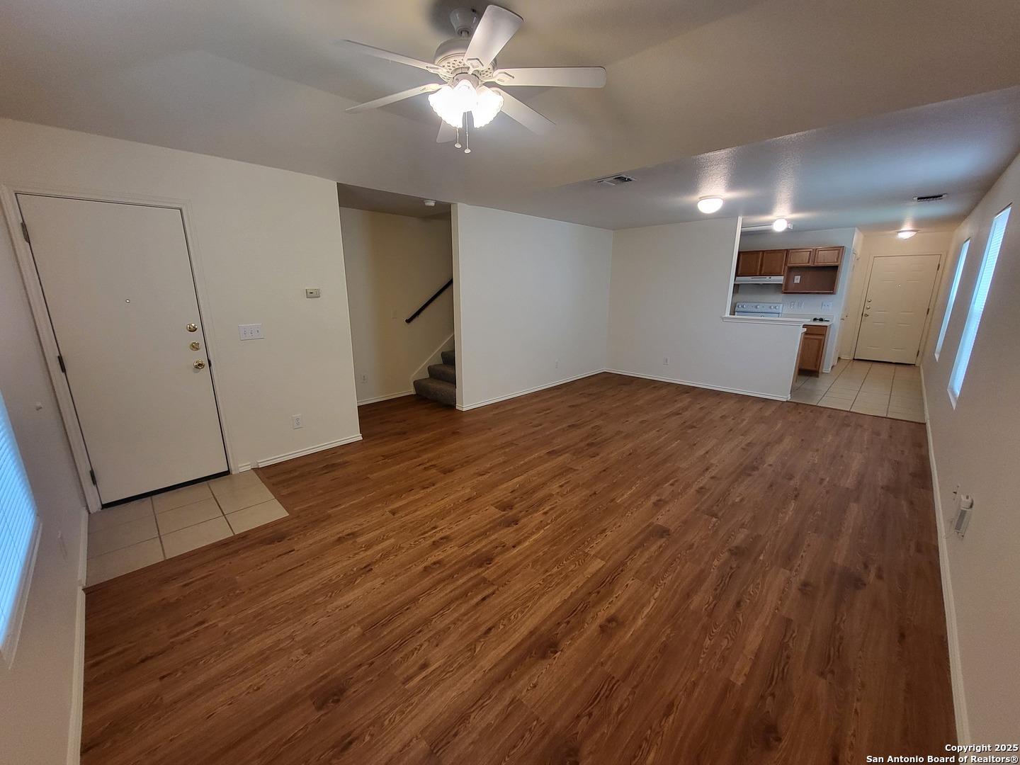 9018 Maverick Draw San Antonio, TX 78250 - Photo 5 of 11 a view of a big room with wooden floor and a ceiling fan