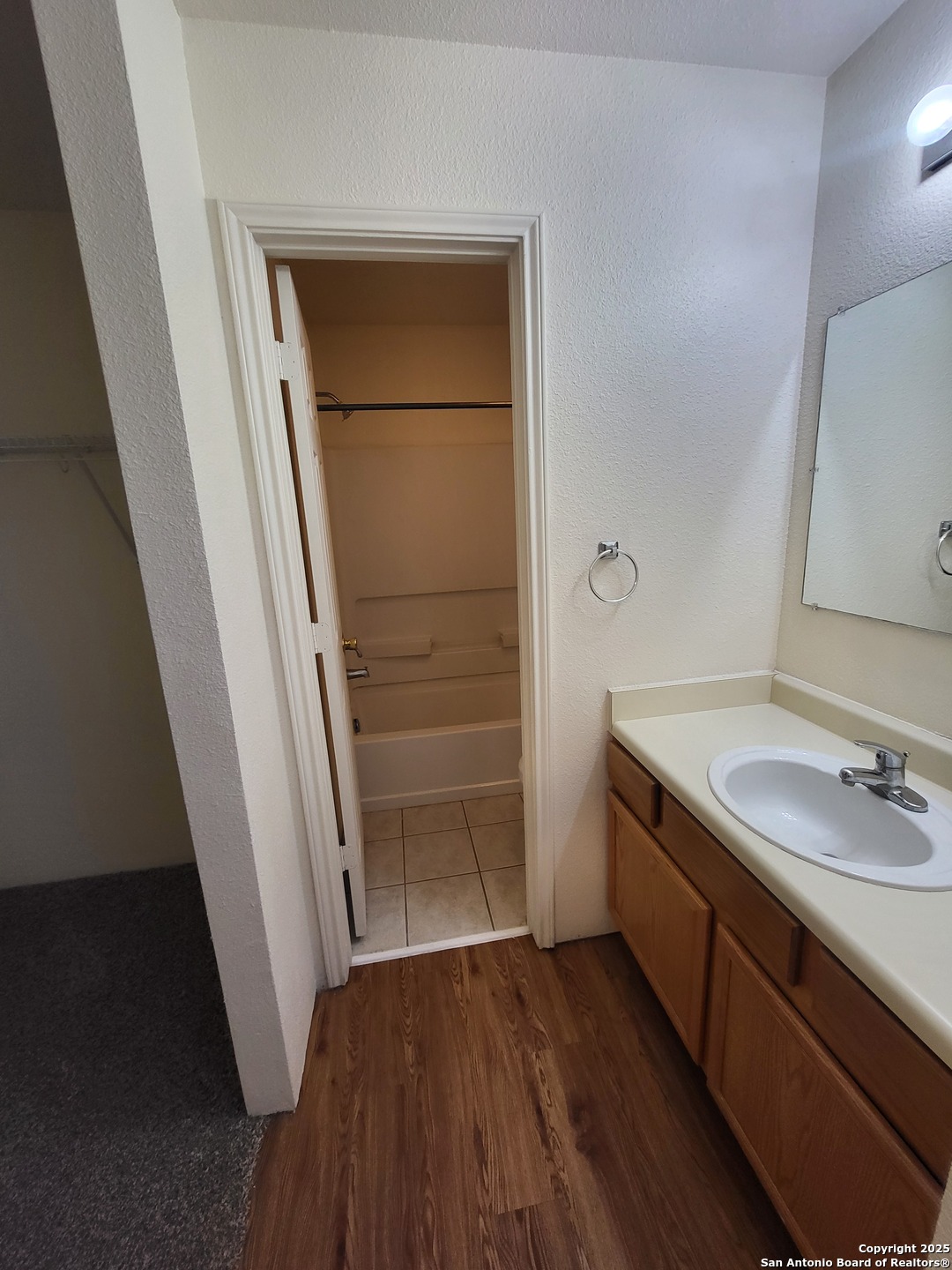 9018 Maverick Draw San Antonio, TX 78250 - Photo 10 of 11 a bathroom with a sink and a mirror