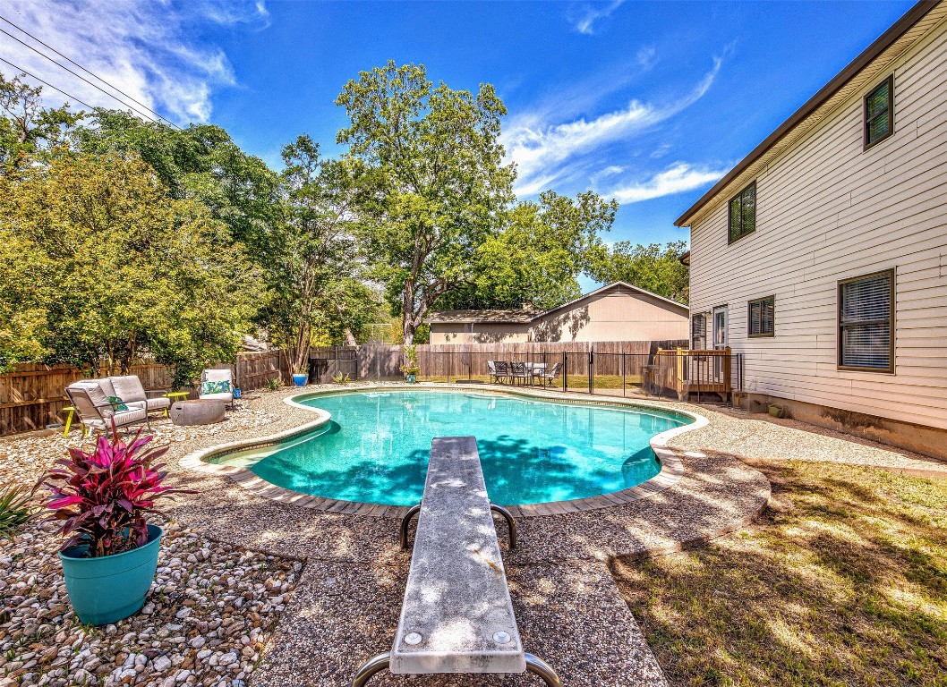 a view of a patio with a table and chairs and potted plants