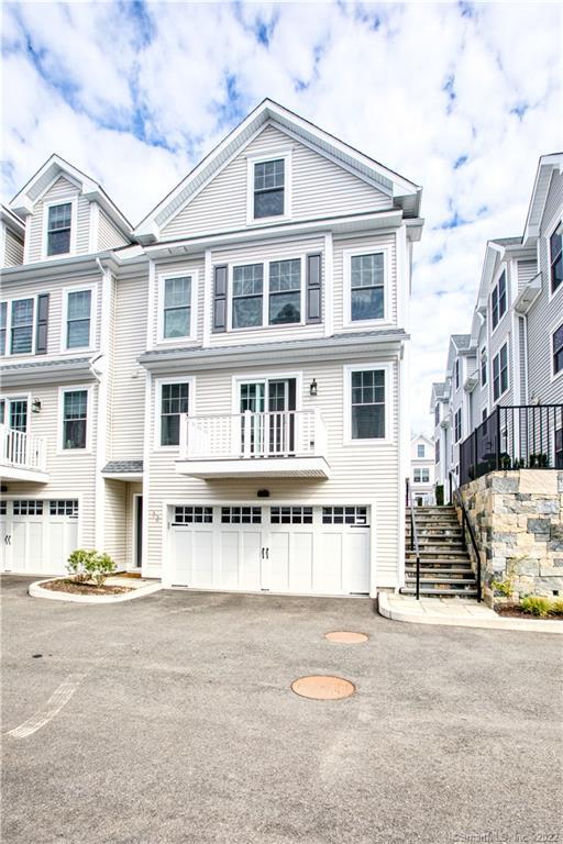 115 Colonial Road, Unit 32 Stamford, CT 06906 - Photo 1 of 1 a front view of a building with street