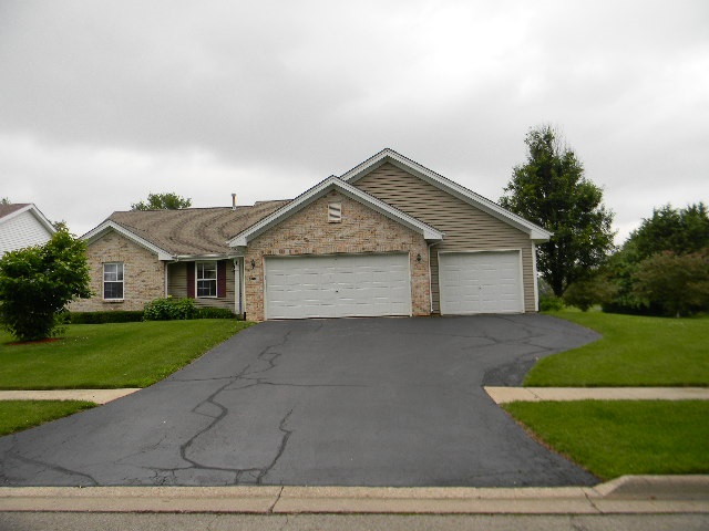 6688 North Point Road Rockford, IL 61108 - Photo 1 of 24 a front view of a house with a yard and garage
