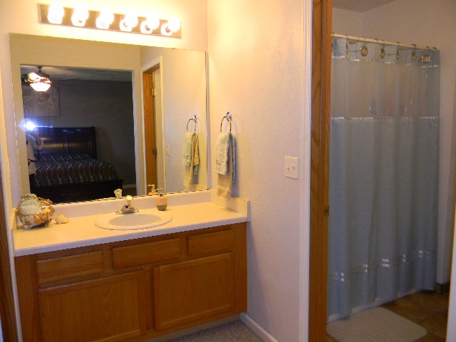 6688 North Point Road Rockford, IL 61108 - Photo 12 of 24 a bathroom with a double vanity sink and a mirror