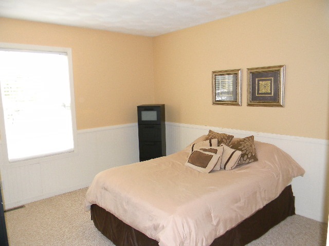 6688 North Point Road Rockford, IL 61108 - Photo 13 of 24 a bedroom with a bed and painting on the wall