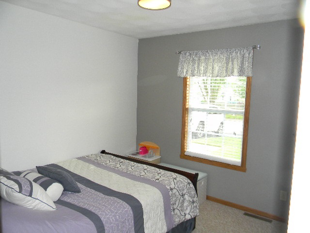 6688 North Point Road Rockford, IL 61108 - Photo 15 of 24 a bedroom with a bed and a window