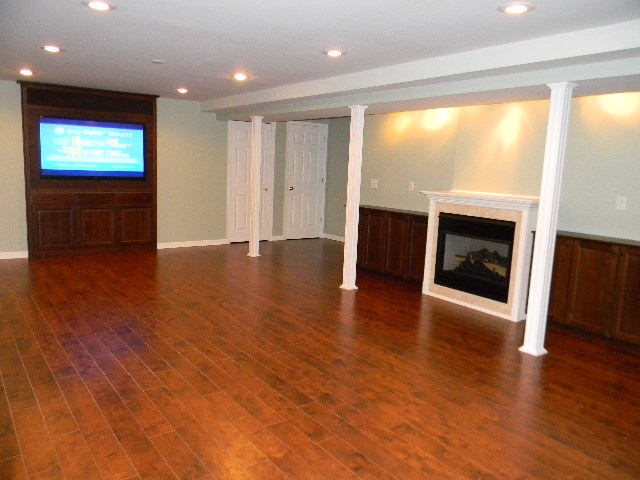 6688 North Point Road Rockford, IL 61108 - Photo 17 of 24 an empty room with wooden floor fireplace and windows