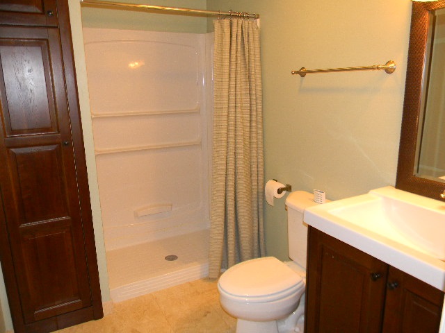 6688 North Point Road Rockford, IL 61108 - Photo 19 of 24 a bathroom with a granite countertop sink toilet and shower