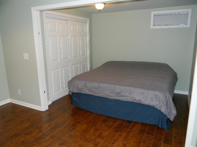 6688 North Point Road Rockford, IL 61108 - Photo 20 of 24 a bedroom with a bed and wooden floor
