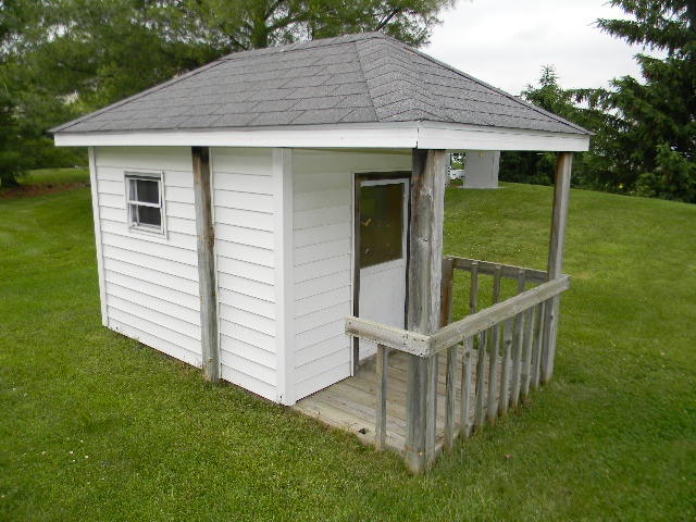 6688 North Point Road Rockford, IL 61108 - Photo 23 of 24 a view of a white house with a small yard and wooden fence