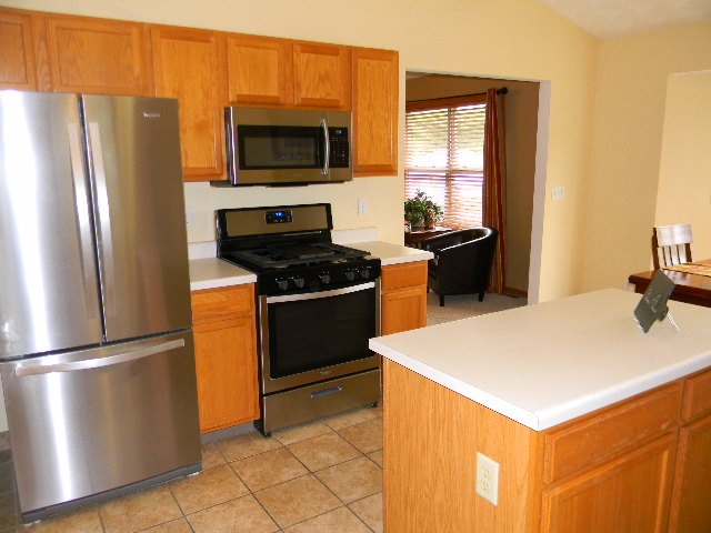 6688 North Point Road Rockford, IL 61108 - Photo 3 of 24 a kitchen with stainless steel appliances a refrigerator a stove a sink and a refrigerator