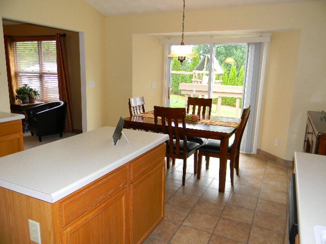 6688 North Point Road Rockford, IL 61108 - Photo 4 of 24 a dining room with furniture a large window and a chandelier