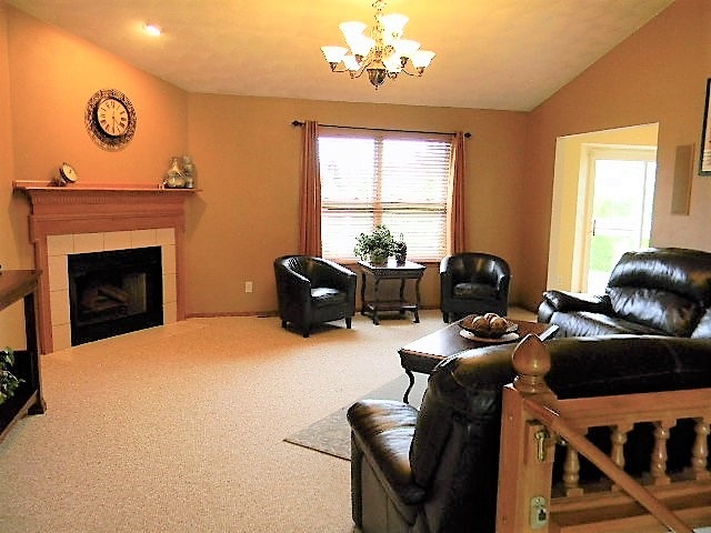 6688 North Point Road Rockford, IL 61108 - Photo 6 of 24 a livingroom with workspace fireplace and dining area