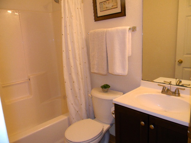 6688 North Point Road Rockford, IL 61108 - Photo 9 of 24 a bathroom with a sink a toilet and shower curtain