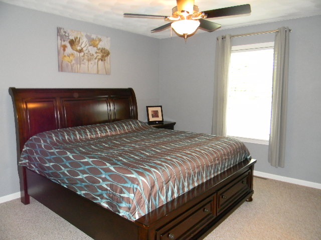 6688 North Point Road Rockford, IL 61108 - Photo 10 of 24 a bedroom with a bed and a chandelier