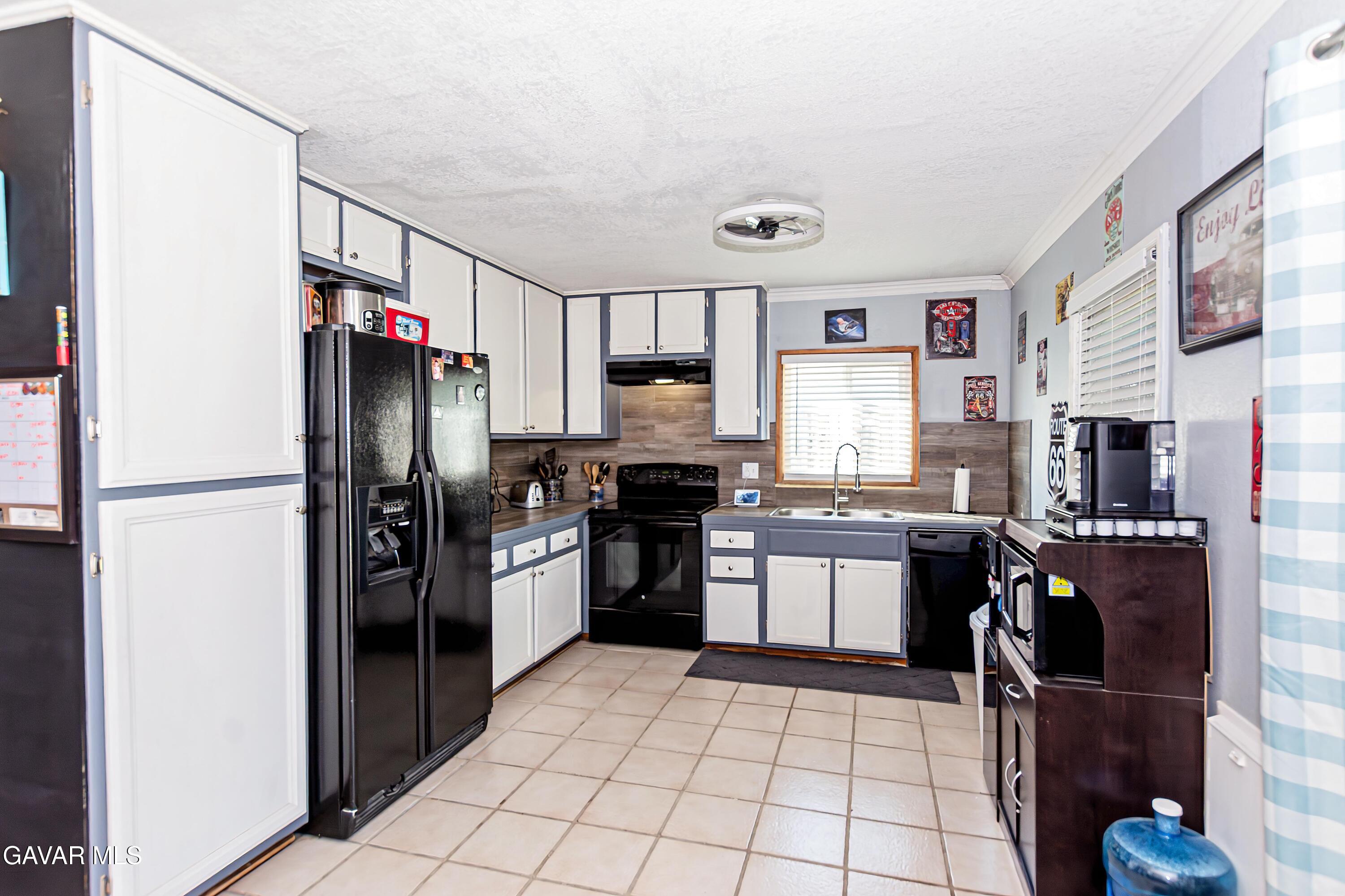 42933 Alexo Drive Lancaster, CA 93536 - Photo 11 of 32 a kitchen with stainless steel appliances granite countertop a refrigerator stove and sink
