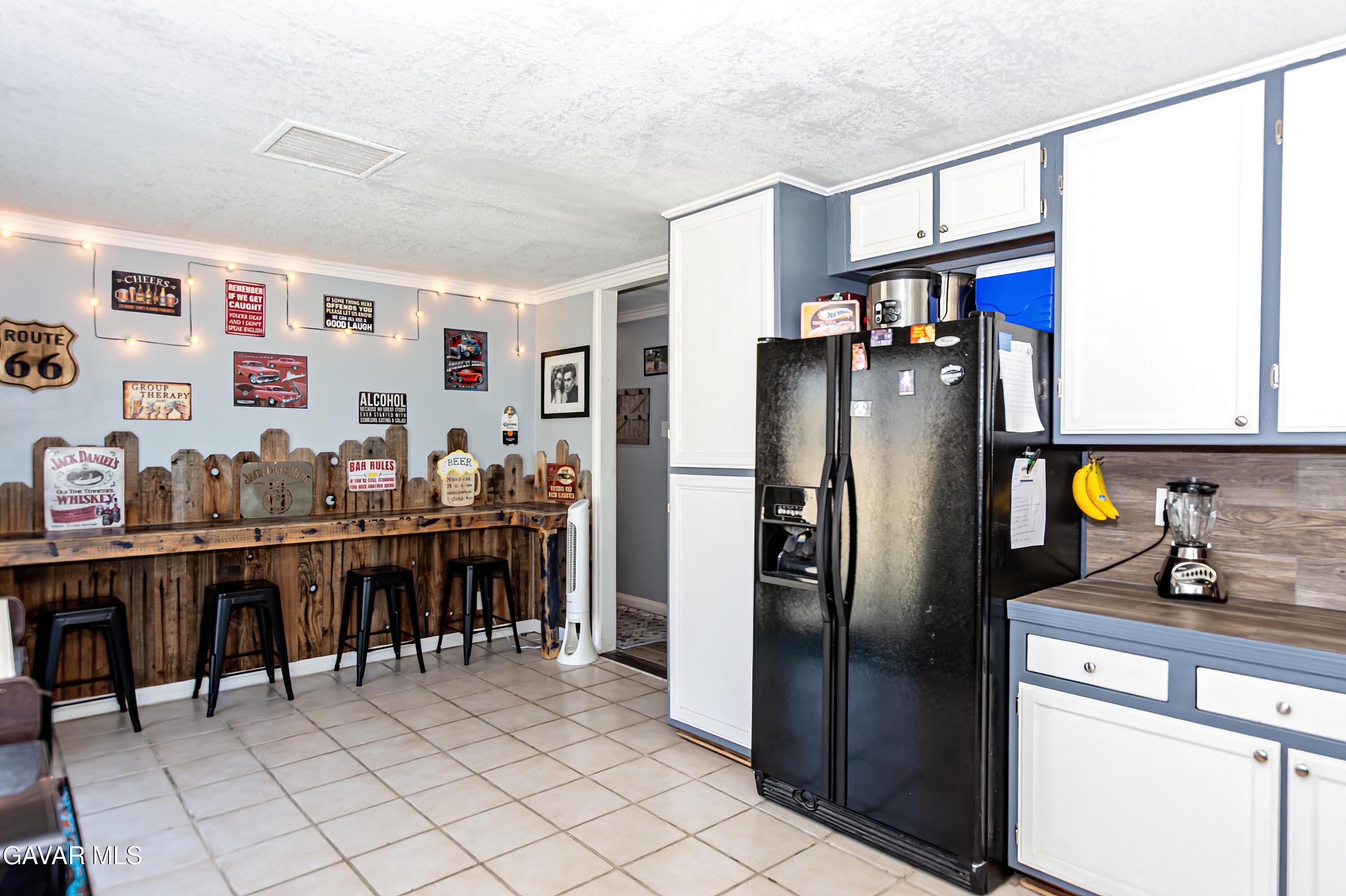 42933 Alexo Drive Lancaster, CA 93536 - Photo 14 of 32 a kitchen with stainless steel appliances granite countertop a refrigerator and a sink