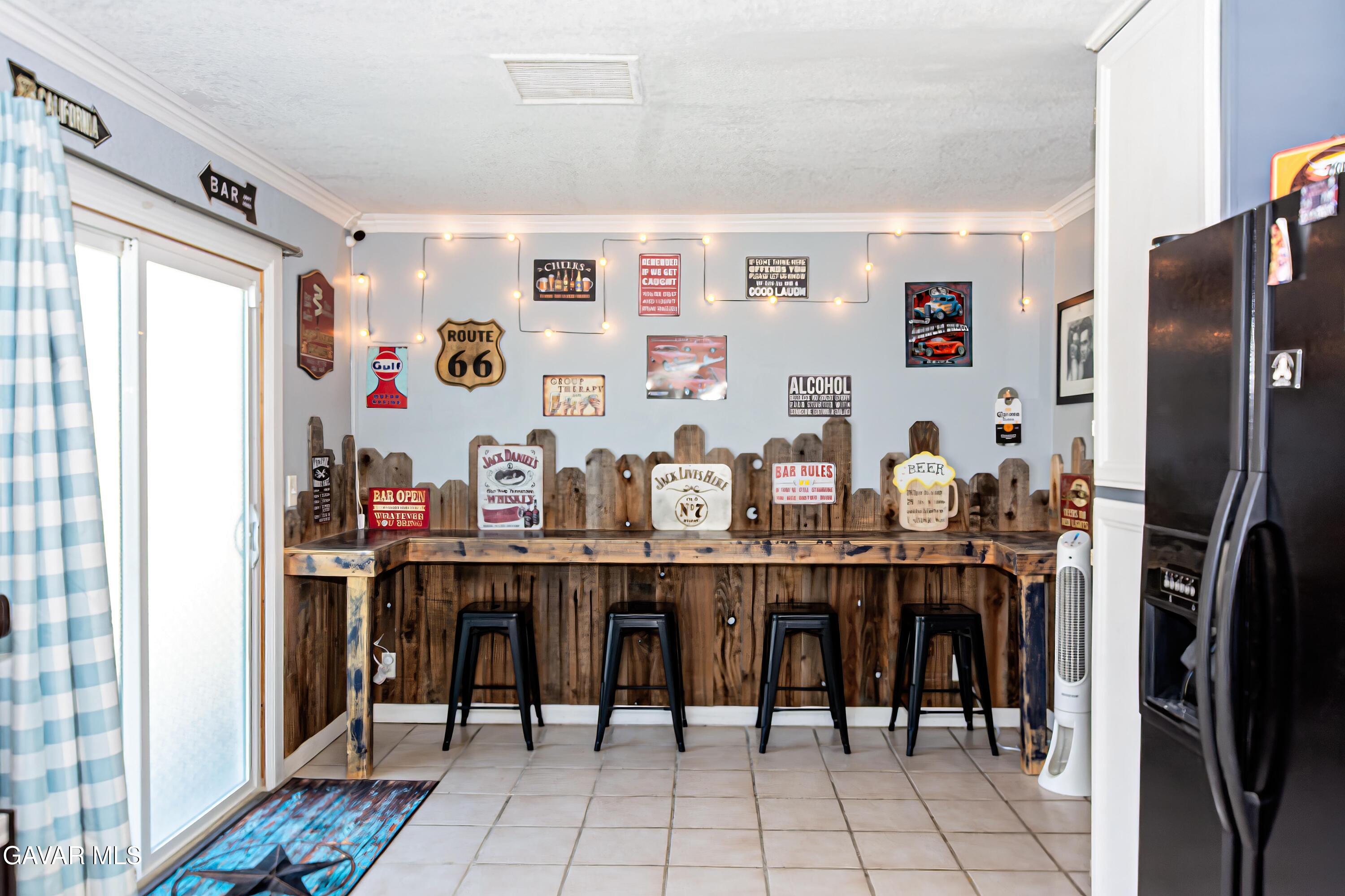 42933 Alexo Drive Lancaster, CA 93536 - Photo 15 of 32 a room with stainless steel appliances lots of wooden furniture