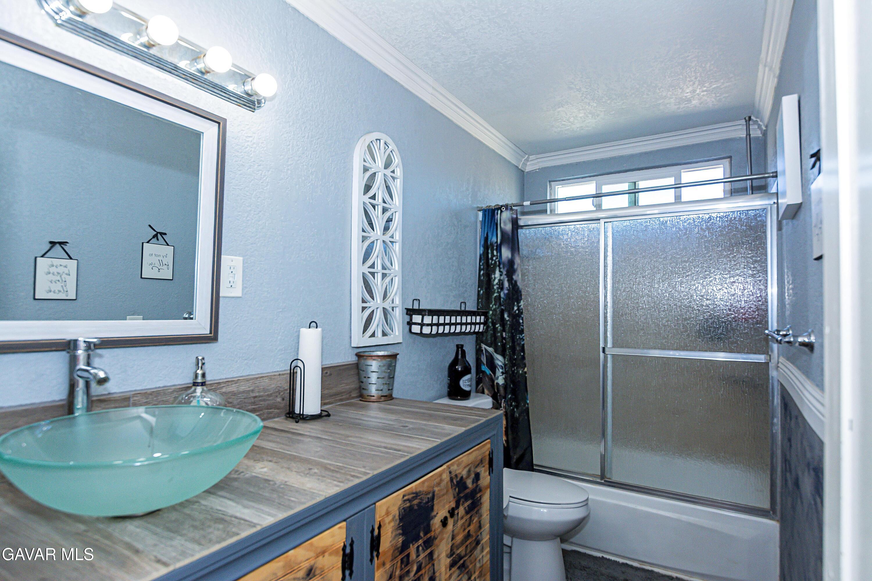 42933 Alexo Drive Lancaster, CA 93536 - Photo 17 of 32 a bathroom with a granite countertop sink and a mirror