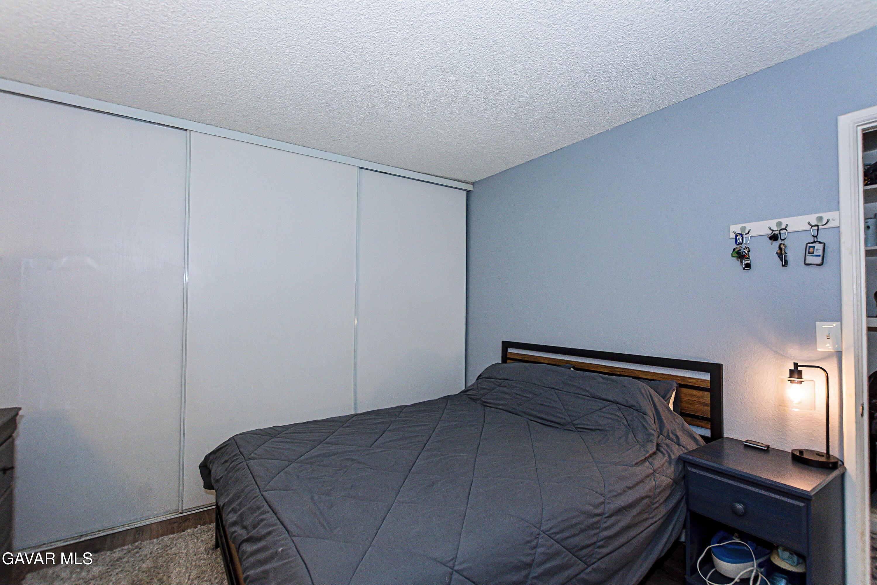 42933 Alexo Drive Lancaster, CA 93536 - Photo 20 of 32 a bedroom with a bed and a window
