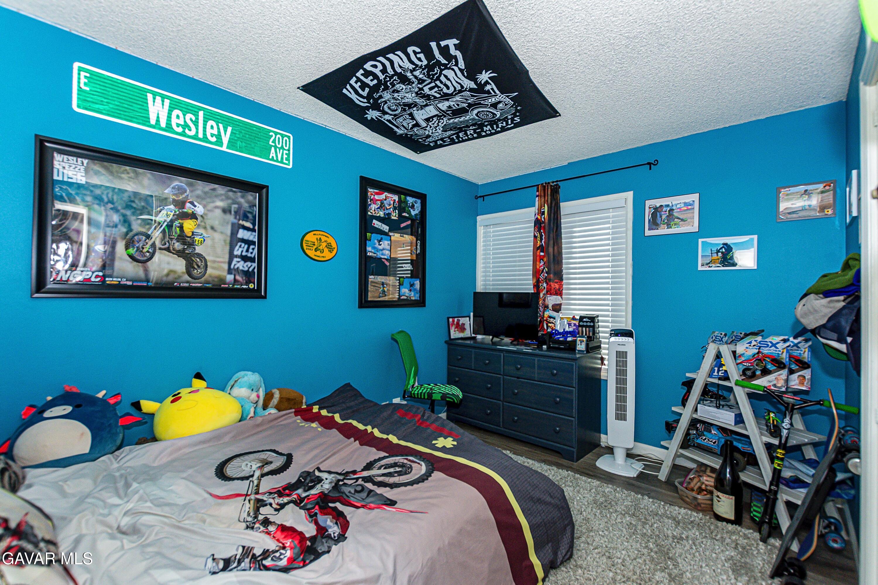 42933 Alexo Drive Lancaster, CA 93536 - Photo 22 of 32 a bedroom with a bed and furniture