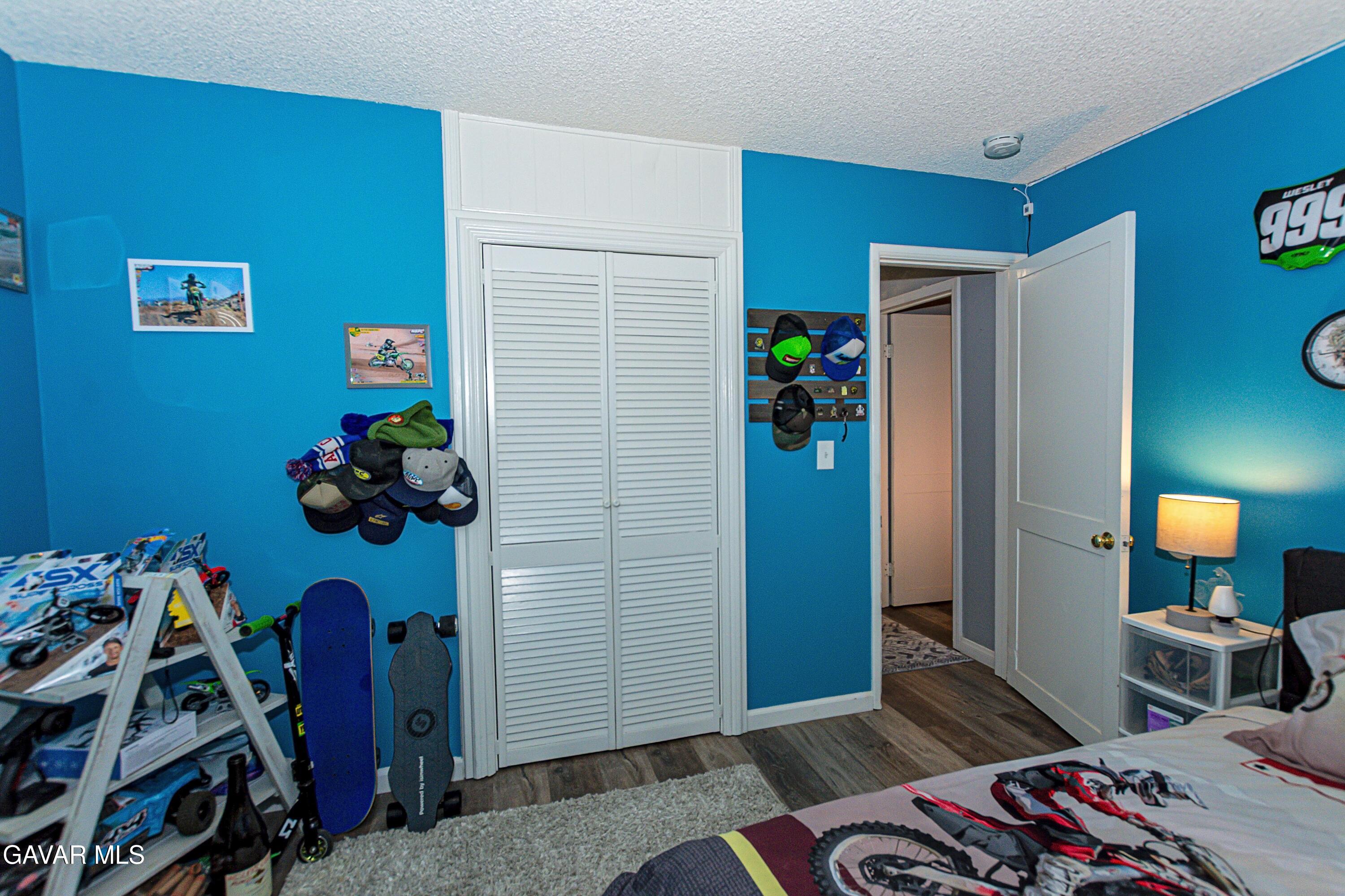 42933 Alexo Drive Lancaster, CA 93536 - Photo 24 of 32 a bedroom with a bed and a window